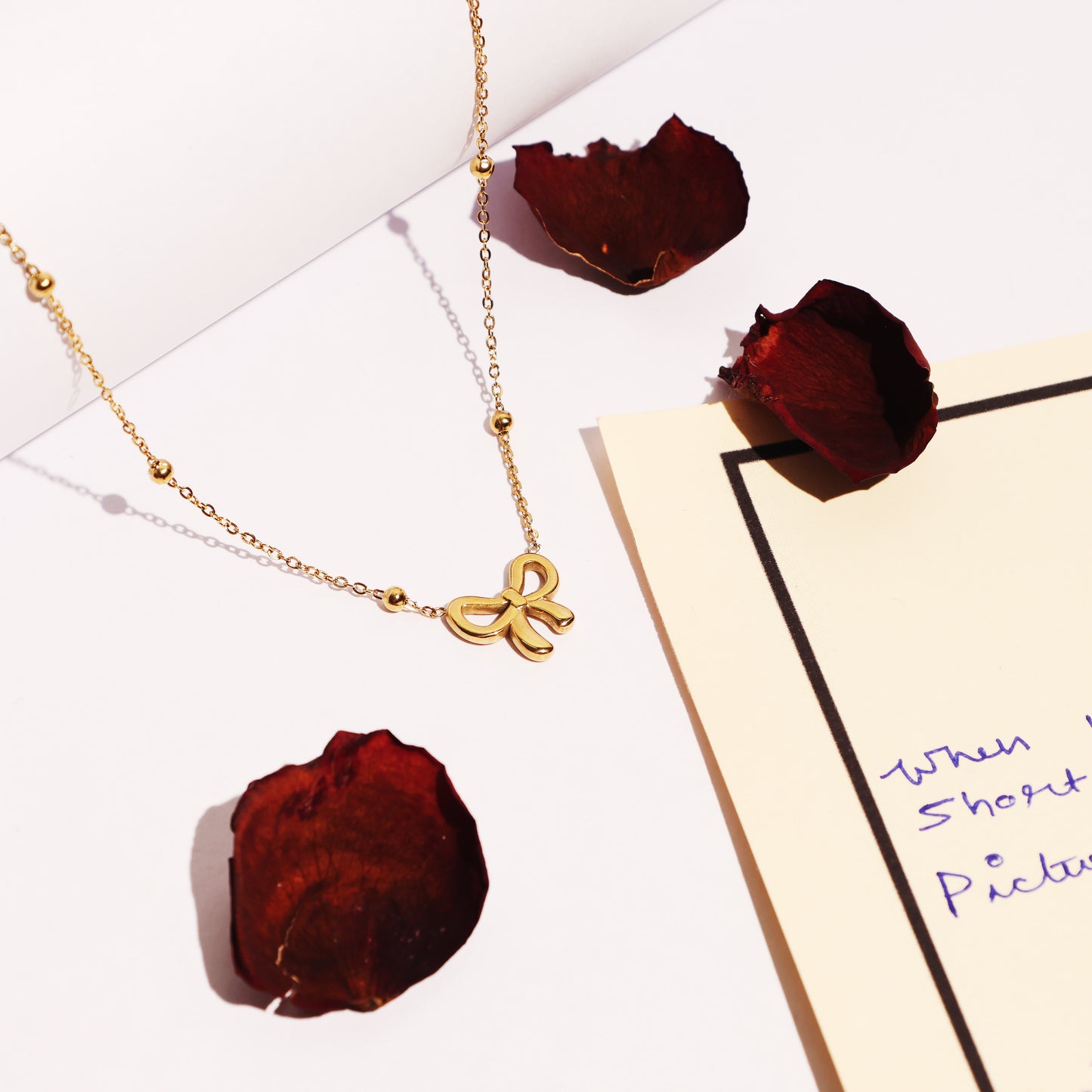 Stallae Golden Bow Pendant Necklace