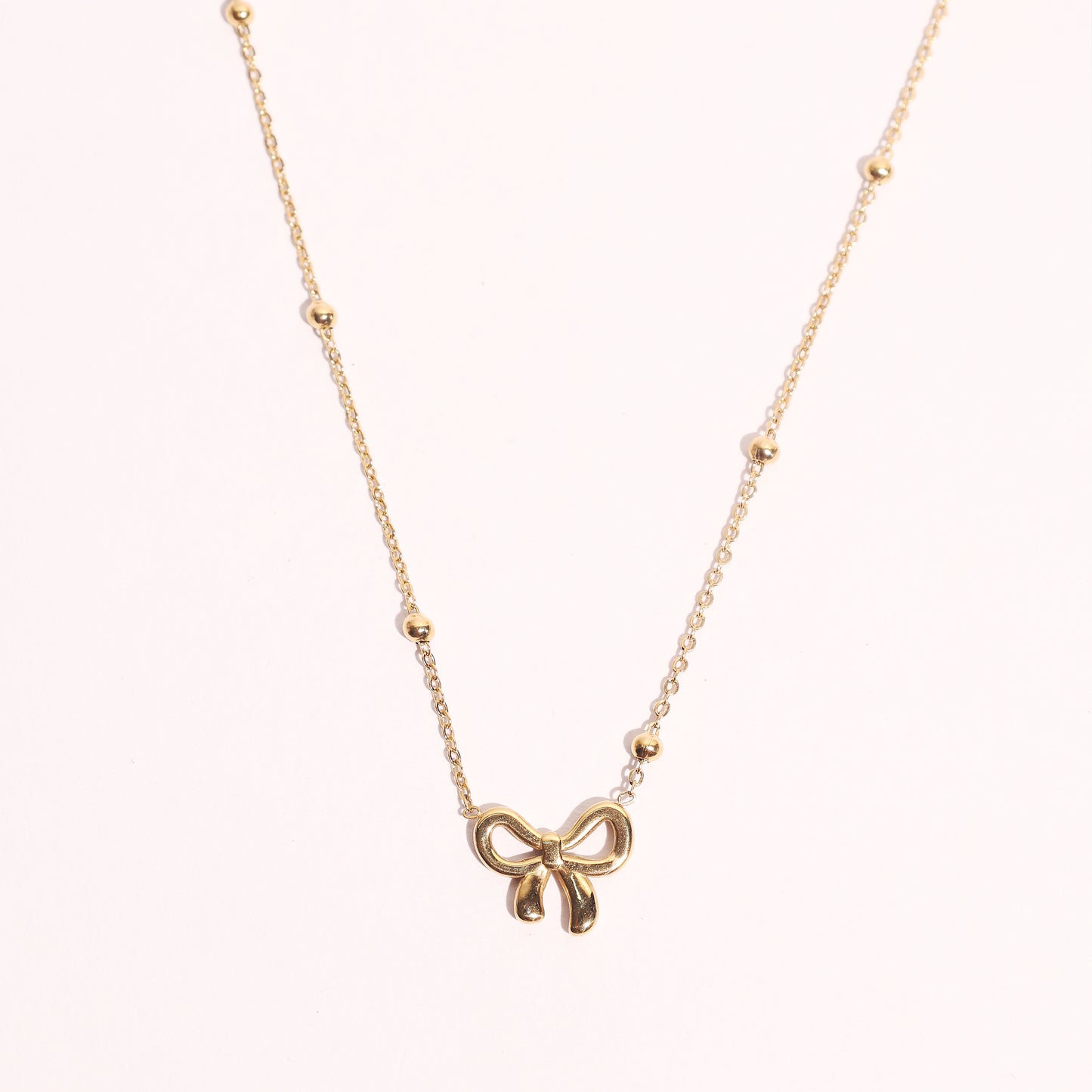 Stallae Golden Bow Pendant Necklace