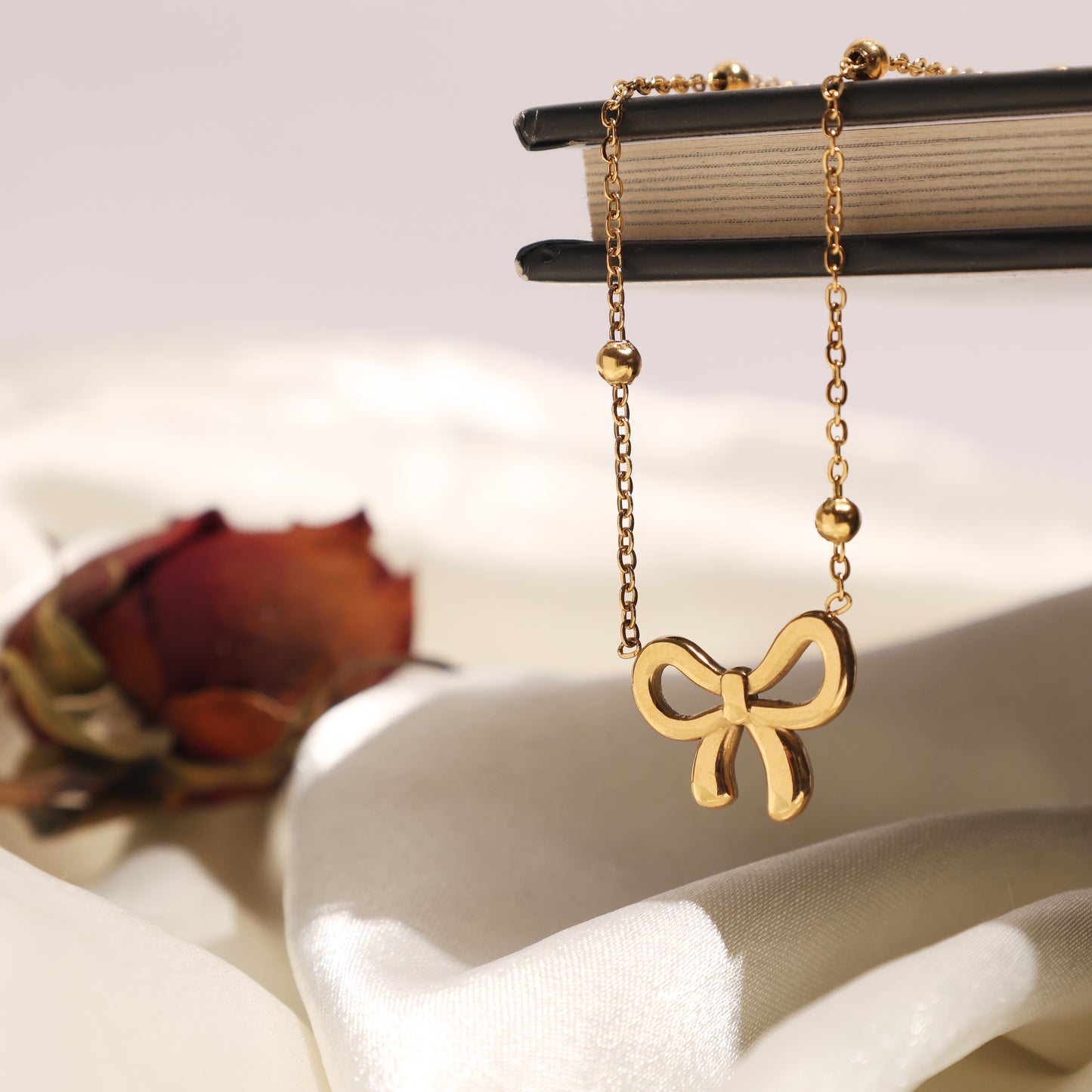 Stallae Golden Bow Pendant Necklace